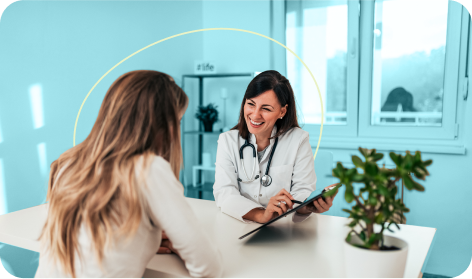 Smiling doctor showing chart to engaged female patient.