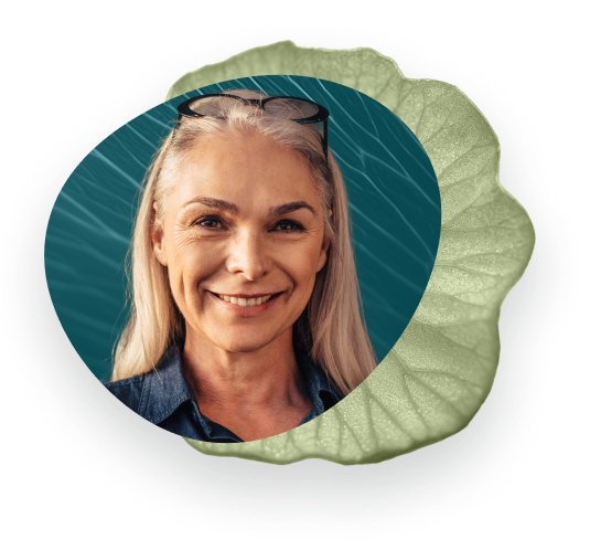 Middle-aged women smiling, glasses on her head